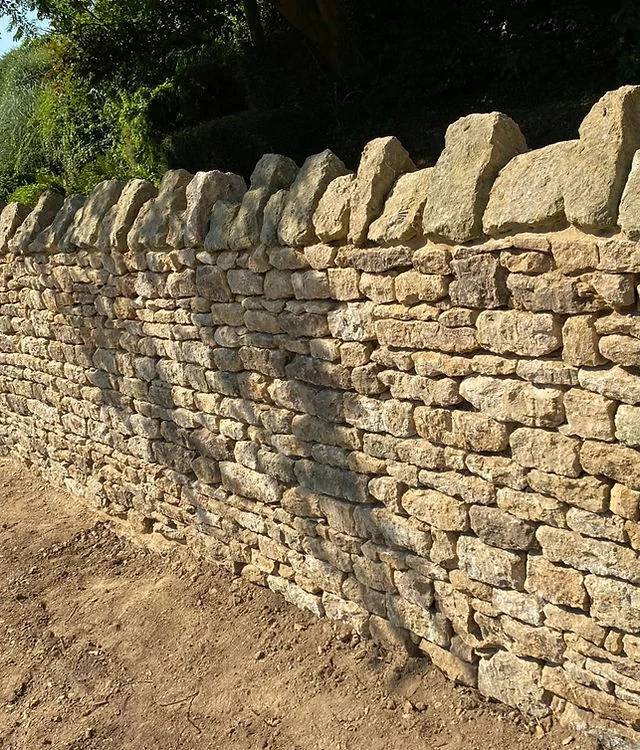 Close view of a coursed dry stone wall under construction
