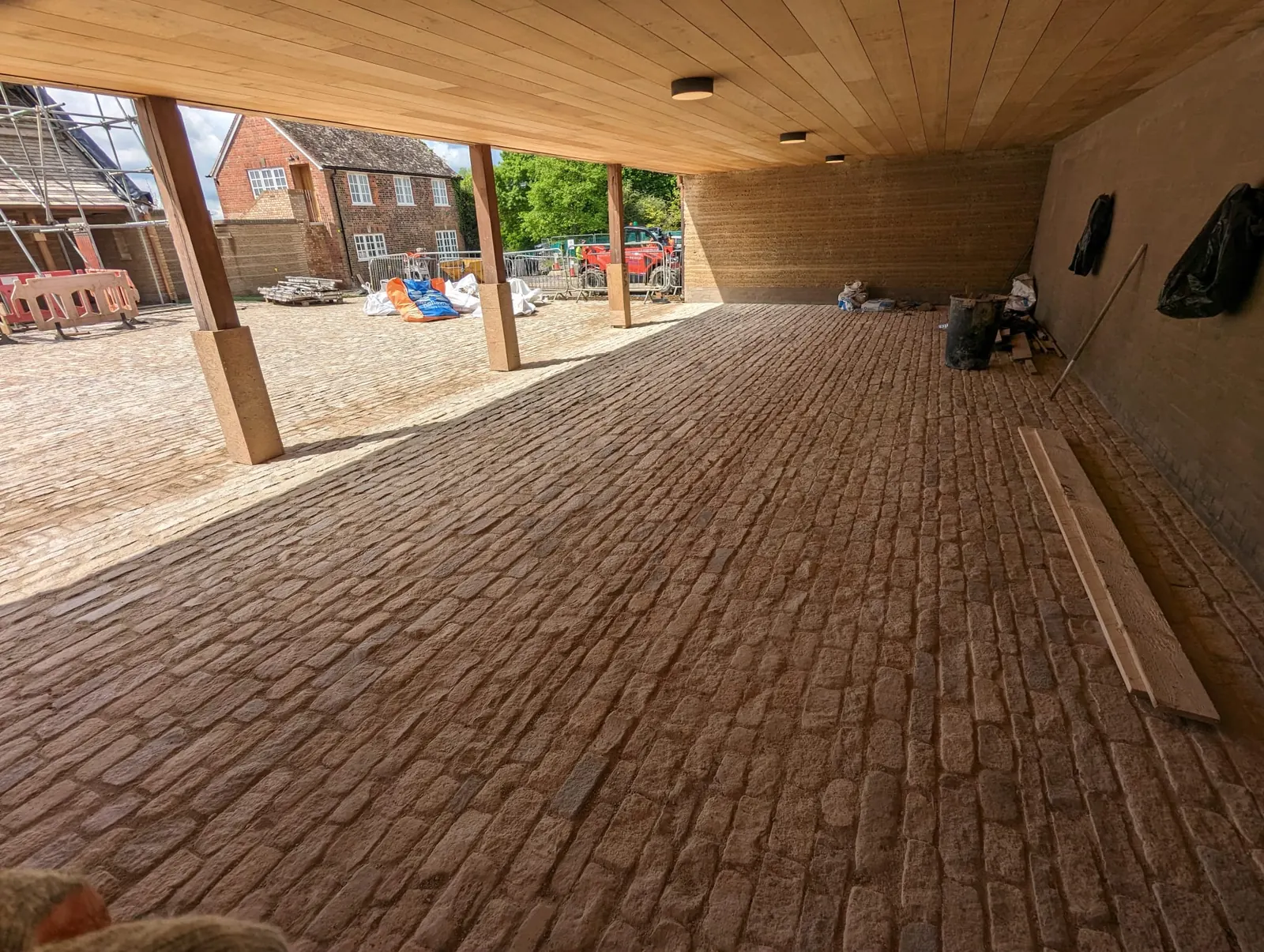 A newly laid cobbled courtyard beneath a timber canopy