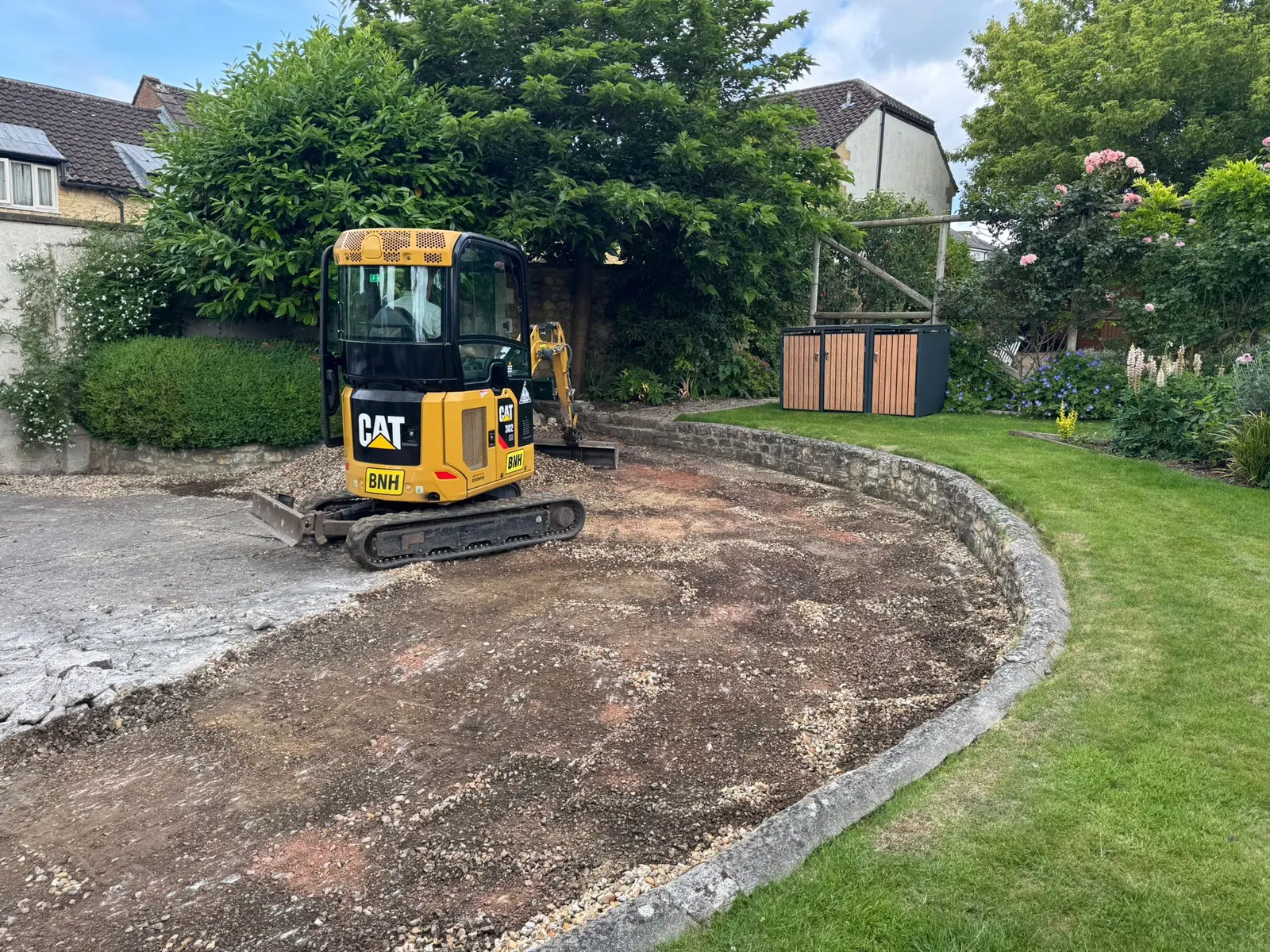 Ground prepared for a curved landscaped garden feature