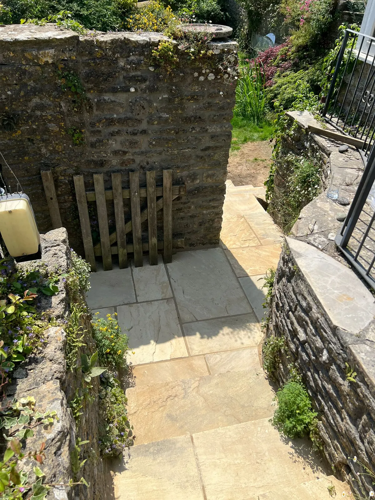 Narrow sandstone steps descending between stone walls