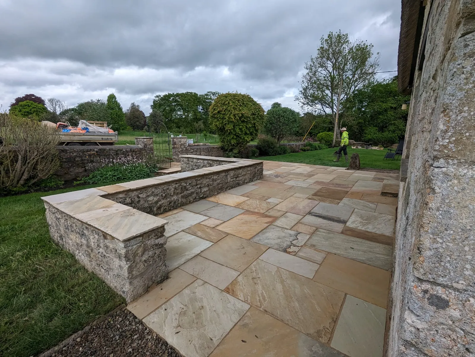 A broad sandstone terrace edged by low stone walls