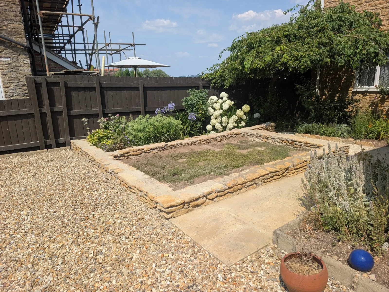 A raised garden area edged with natural stone
